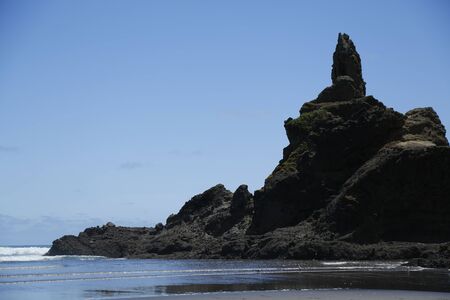 Rock formations at Phia beach in Auckland, New Zealand.  With the sand, sea and sky.の写真素材