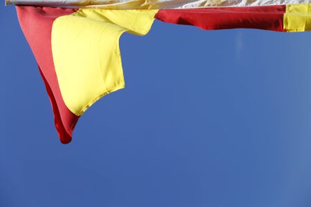 The flags of the New Zealand life saving in the blue sky.の写真素材