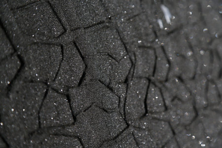 Tire tracks in the sand close up.