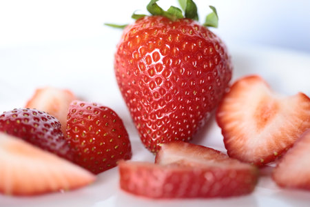 Whole and cut strawberries.の写真素材