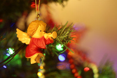 An angel decoration hanging on a Christmas tree.の写真素材