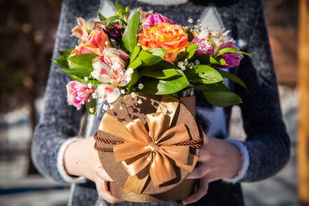 Girl hold flowers in handsの写真素材