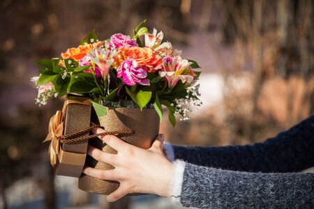 Girl hold flowers in handsの写真素材