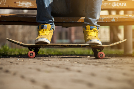 young skateboarder legs skateboarding at skateparkの写真素材