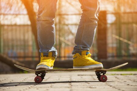 young skateboarder legs skateboarding at skateparkの写真素材
