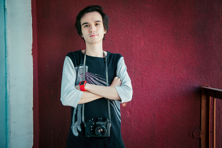 Cute yong photographer take shot in his vintage style cameraの写真素材