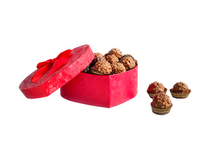 Red open box in the form of heart with chocolatesの写真素材