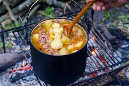 The cooking of soup on the fire on the campingの写真素材