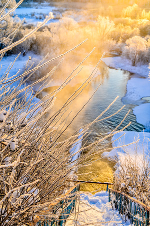 Winter sunny landscape with river and forest.の写真素材