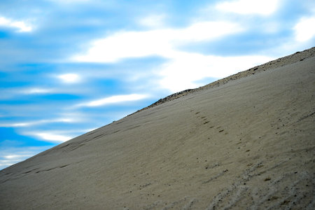 Sandy hill in a quarry against the sky.の写真素材