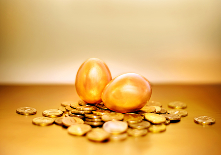 Gold coins and golden eggs, the concept of financial growth.の写真素材