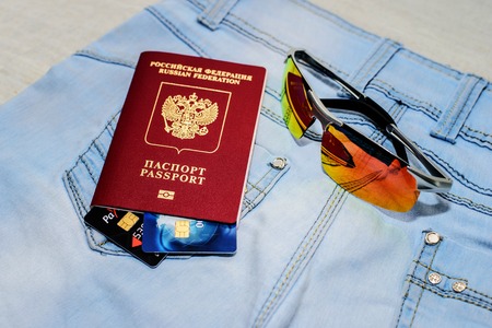 Red russian Passport with bank cards, glasses and seashells. The concept of travelの写真素材