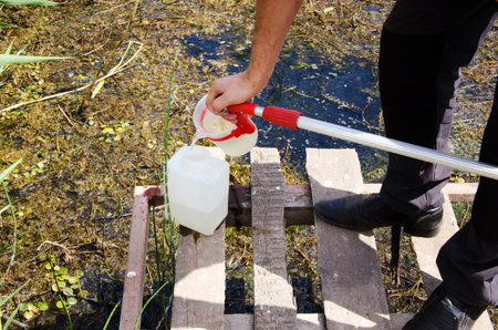 Take samples of water for laboratory testing. The concept - analysis of water purity, environment, ecology