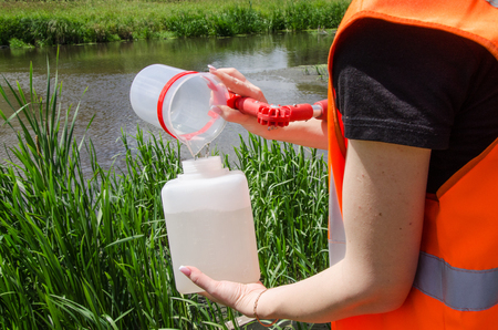 Take samples of water for laboratory testing. The concept - analysis of water purity, environment, ecologyの写真素材
