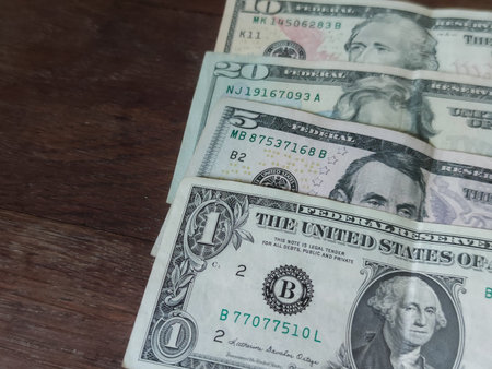 Dollars on a wooden background. American money banknotes.