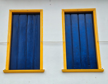 Large wooden window in blue, in the style of a colonial house, a unique architectural style, typical...