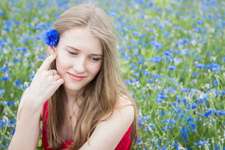 Portrait of young beautiful smiling girl with flowers in her hairの写真素材