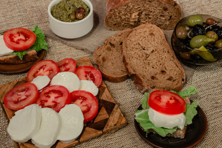 Italian food mix - mozzarella, tomatoes, olives, olive paste and bread