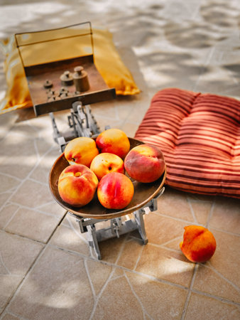 Fresh ripe peaches on old vintage metal scales with weights. Fruit weighing.の写真素材