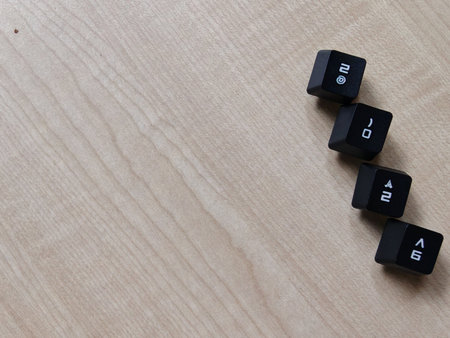 Minimal concept image of black keyboard keys forming 2026 on wooden surface with copy space, symbolizing future, planning, and digital technologyの写真素材