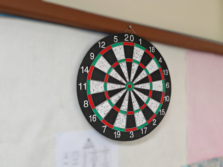Standard dartboard with numbered sections and scoring rings mounted on indoor wall