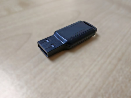 Black USB flash drive with textured grip for portable digital file storage and transfer