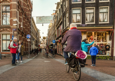 Amsterdam street view with people walking and on the bikes, October 7, 2017のeditorial素材