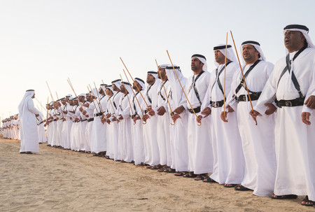 Men perform Yawalah traditional dance  in SHEIKH ZAYED HERITAGE FESTIVAL September 22, 2014 in Abu Dhabi, united arab emiratesのeditorial素材