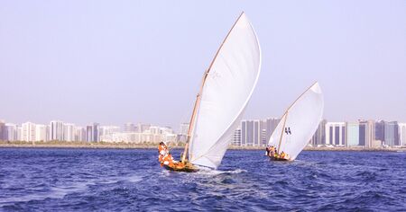Traditional sailing dhows race at  Abu Dhabi at Ghanada Dhow Sailing Raceの写真素材