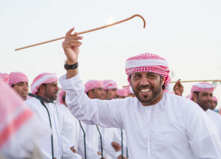Man perform a Yawalah traditional dance in  Al Dafrah festival in September 12, 2014 Abu Dhabi, UAEのeditorial素材
