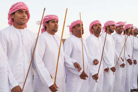 Emirati Men perform a Yawalah traditional dance in  Al Dafrah festival in September 12, 2014 Abu Dhabi, UAEのeditorial素材