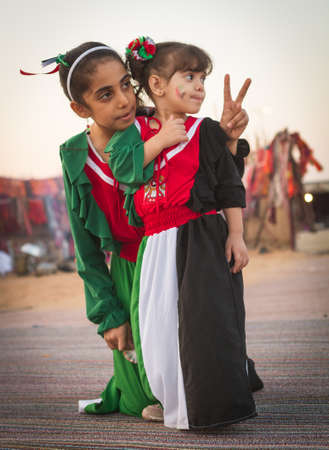 Two children wear national UAE dress from Al Dafrah festival in Septumber 12, 2014 Abu Dhabi UAEのeditorial素材