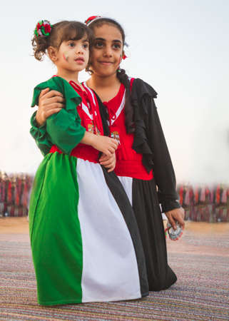 Two children wear national UAE dress from Al Dafrah festival in Septumber 12, 2014 Abu Dhabi UAEのeditorial素材