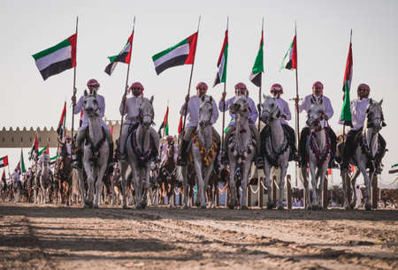 Camel Riders line up to race at the Al Wathba Sheikh Zayed Heritage Festival in Al Wathba, Abu Dhabi, 22 Nobember 2014のeditorial素材