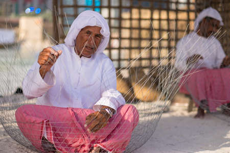 Man Making Fishing Traps or traditional fishing cages in qasr al hosn festival in Abu Dhabi in February 15, 2015のeditorial素材