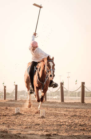 Riding arabian horsesin in Sheikh Zayed Heritage Festival, september 22, 2014 in Abu Dhab, united arab emiratesのeditorial素材