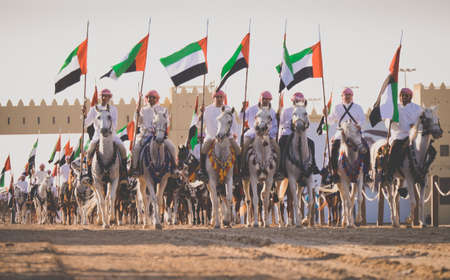 Camel Riders line up to race at the Al Wathba Sheikh Zayed Heritage Festival in Al Wathba, Abu Dhabi, 22 Nobember 2014のeditorial素材