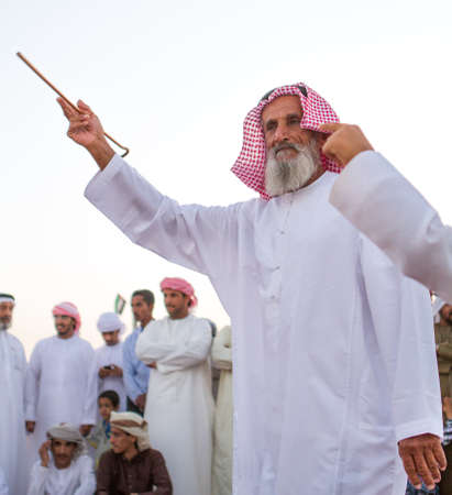 Men perform yola dance in western region Abu Dhabi in December 9, 2012のeditorial素材
