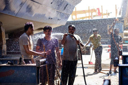 Indian and Bengali Workers repairing old wooden ships and Dhows cruise in Dubai, UAE on 13.10.2014のeditorial素材