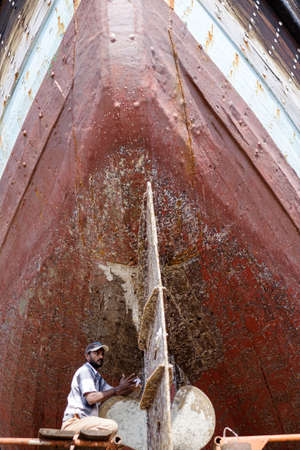 Indian and Bengali Workers repairing old wooden ships and Dhows cruise in Dubai, UAE on 13.10.2014のeditorial素材