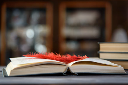 Open book with a bookmark on a wooden table.