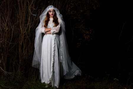Creepy dead bride at night in a swamp. Halloween scene