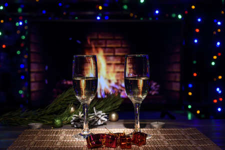 Two glasses with wine on the table against the background of the fireplace.の写真素材
