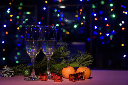 Two glasses of wine on the table. Christmas New Year lights and decorations.の写真素材