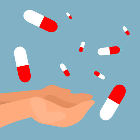 pills falling into the hands with blue backgroundの写真素材