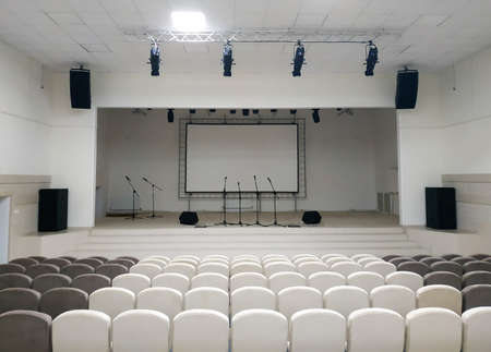 Assembly hall is empty and white with equipment before decoration after repair and constructionの写真素材