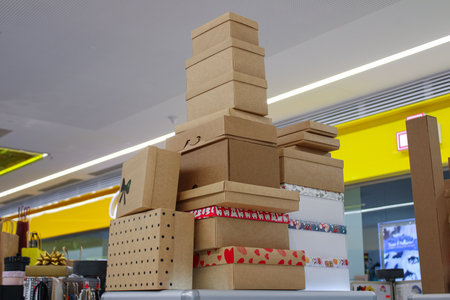 big pile a stack of cardboard holiday boxes and gift packages on display in a shopping mallの写真素材