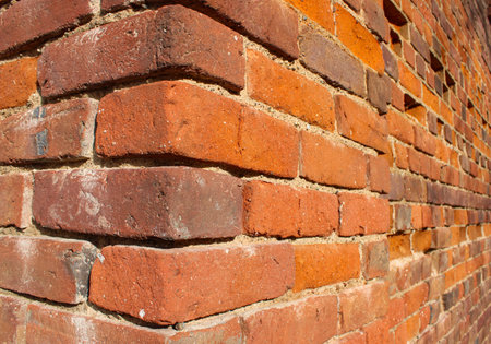 Corner of the detailed ancient wall with the fallen parts made of ancient red brick with stone inclusions which is more than 300 years oldの写真素材