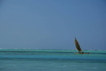 a boat sailing on a clam blue sea