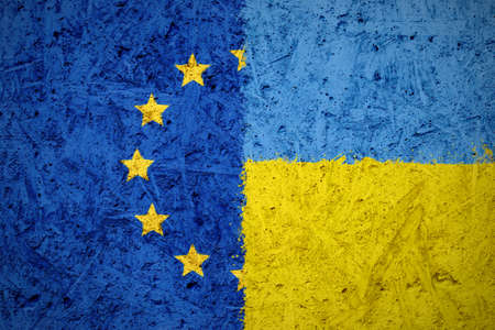 Combination of European Union and Ukraine flags on the concrete textureの写真素材